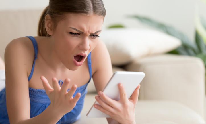 Anxious woman checking phone